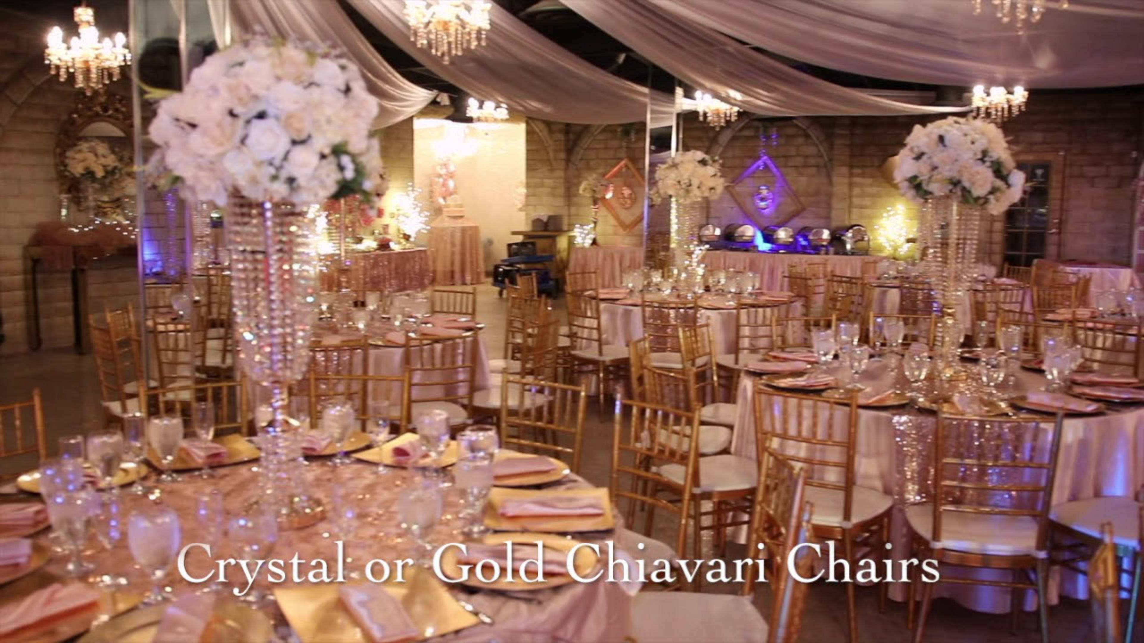 Las Vegas Round dining tables & metal chairs with white roses & crystal arrangements for a wedding event in Sunset Castle banquet hall in Henderson, Nevada